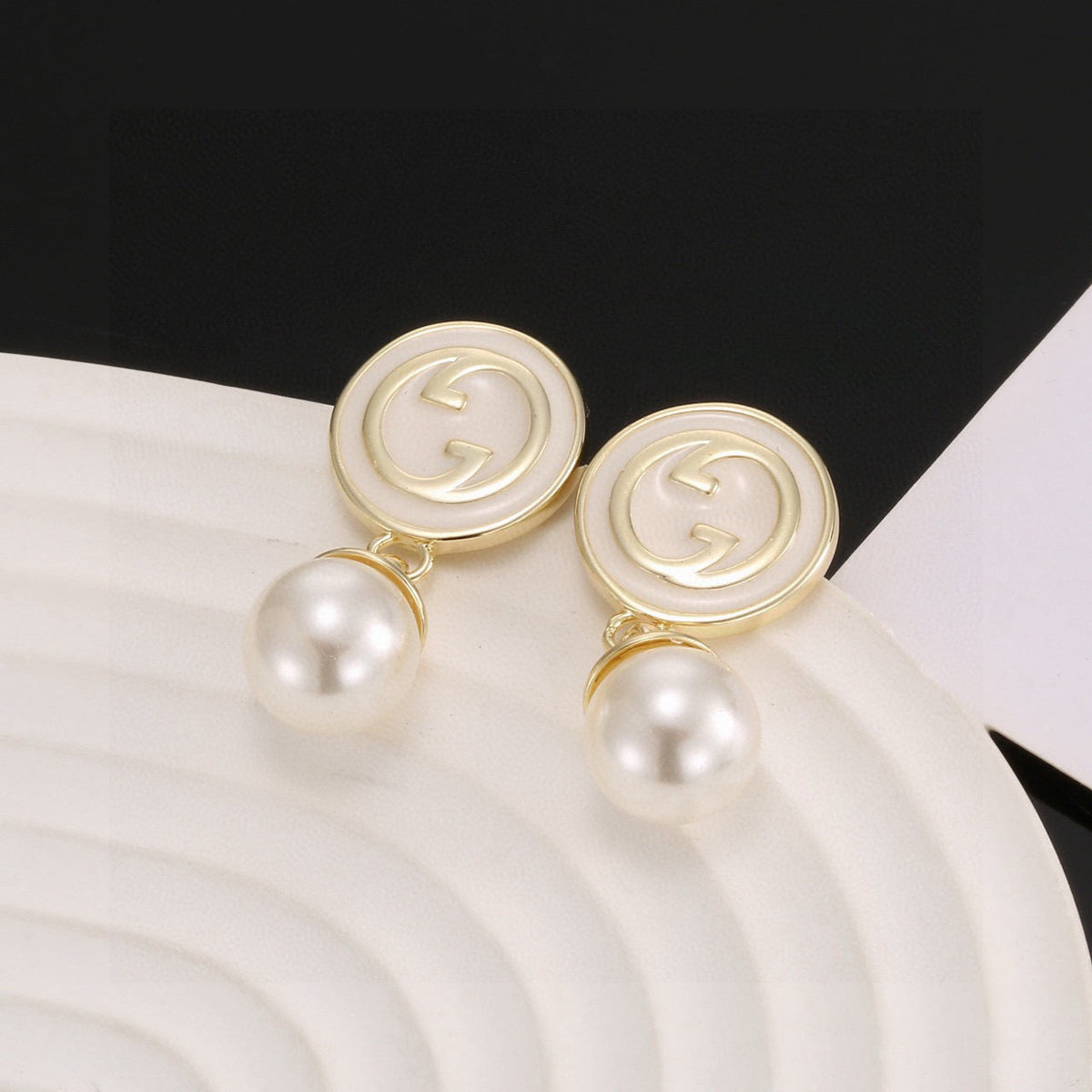Martin Graham stud earrings in polished metal-tone – side detail