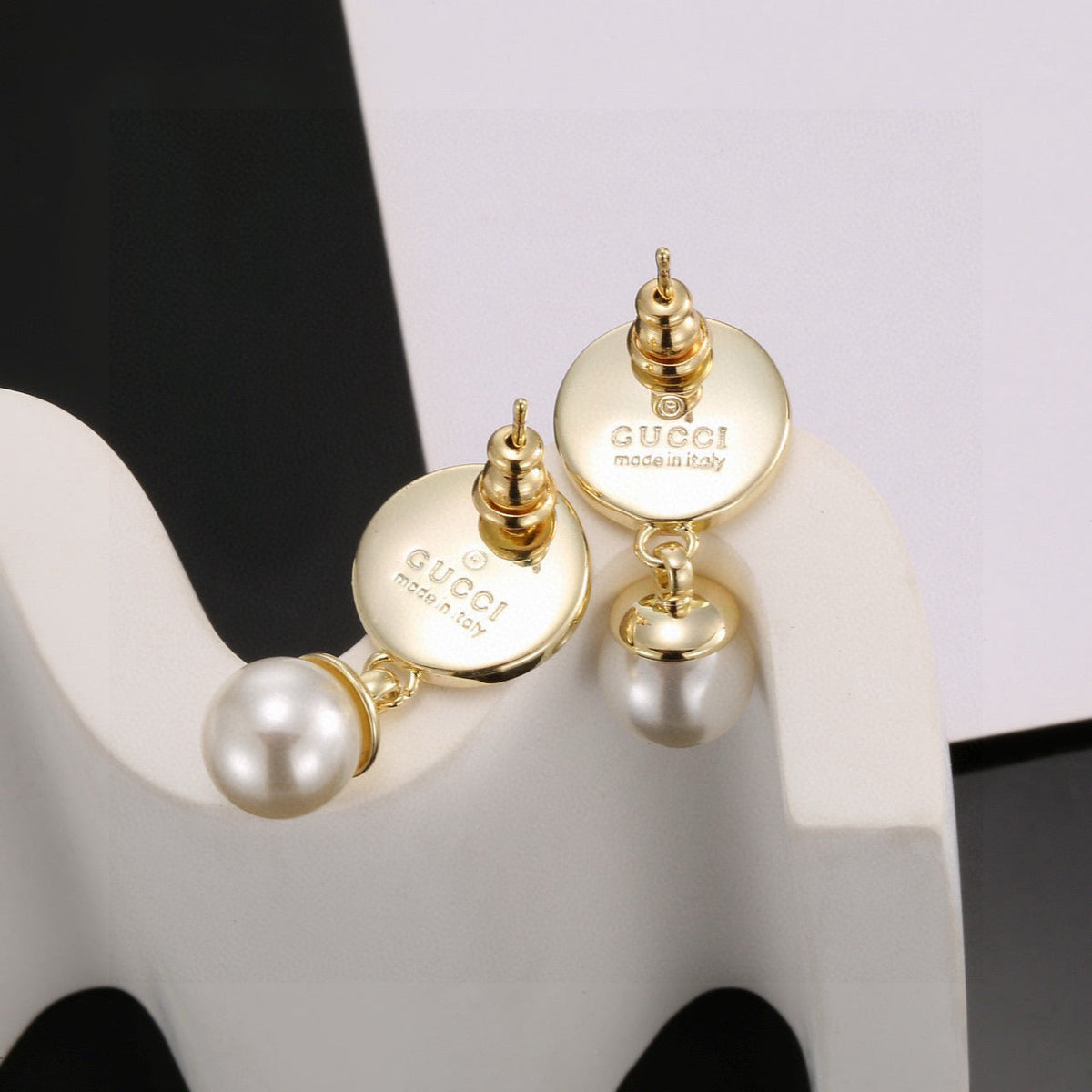Martin Graham stud earrings in polished metal-tone – close-up detail