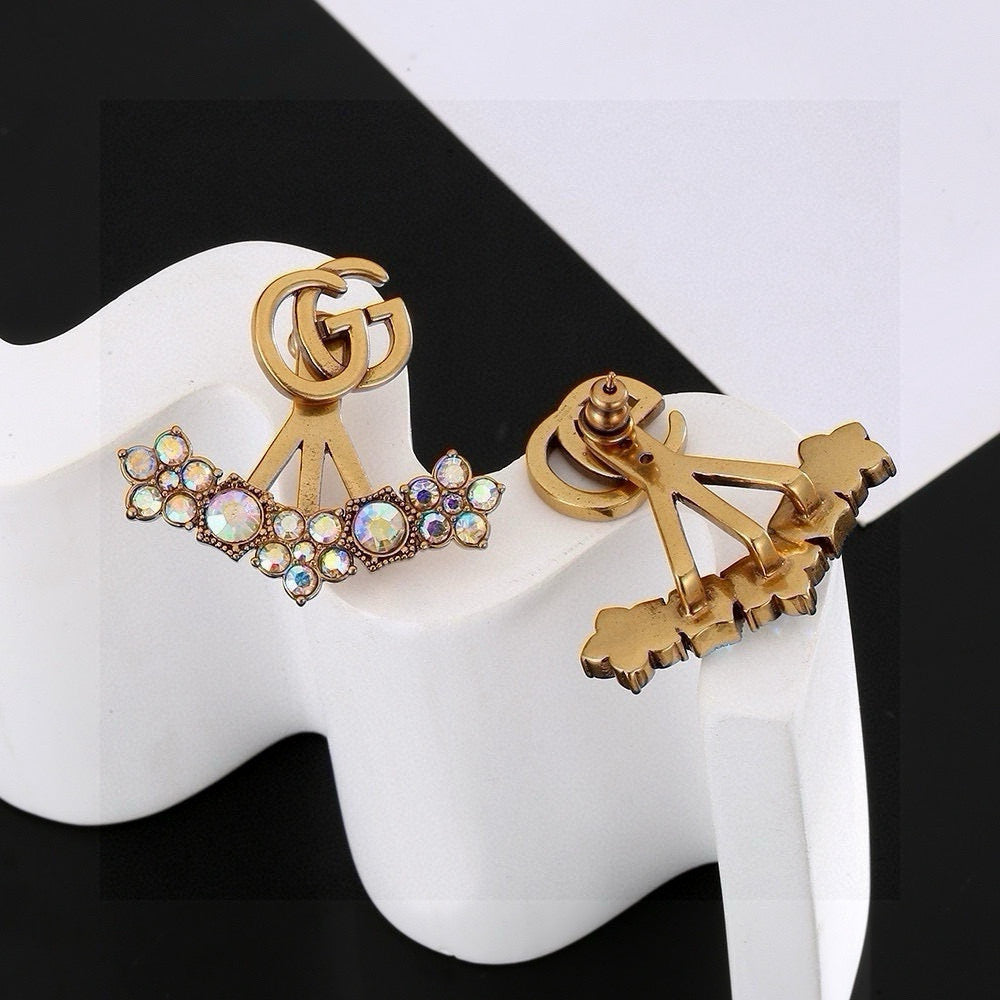 Martin Graham stud earrings in polished metal-tone – close-up detail