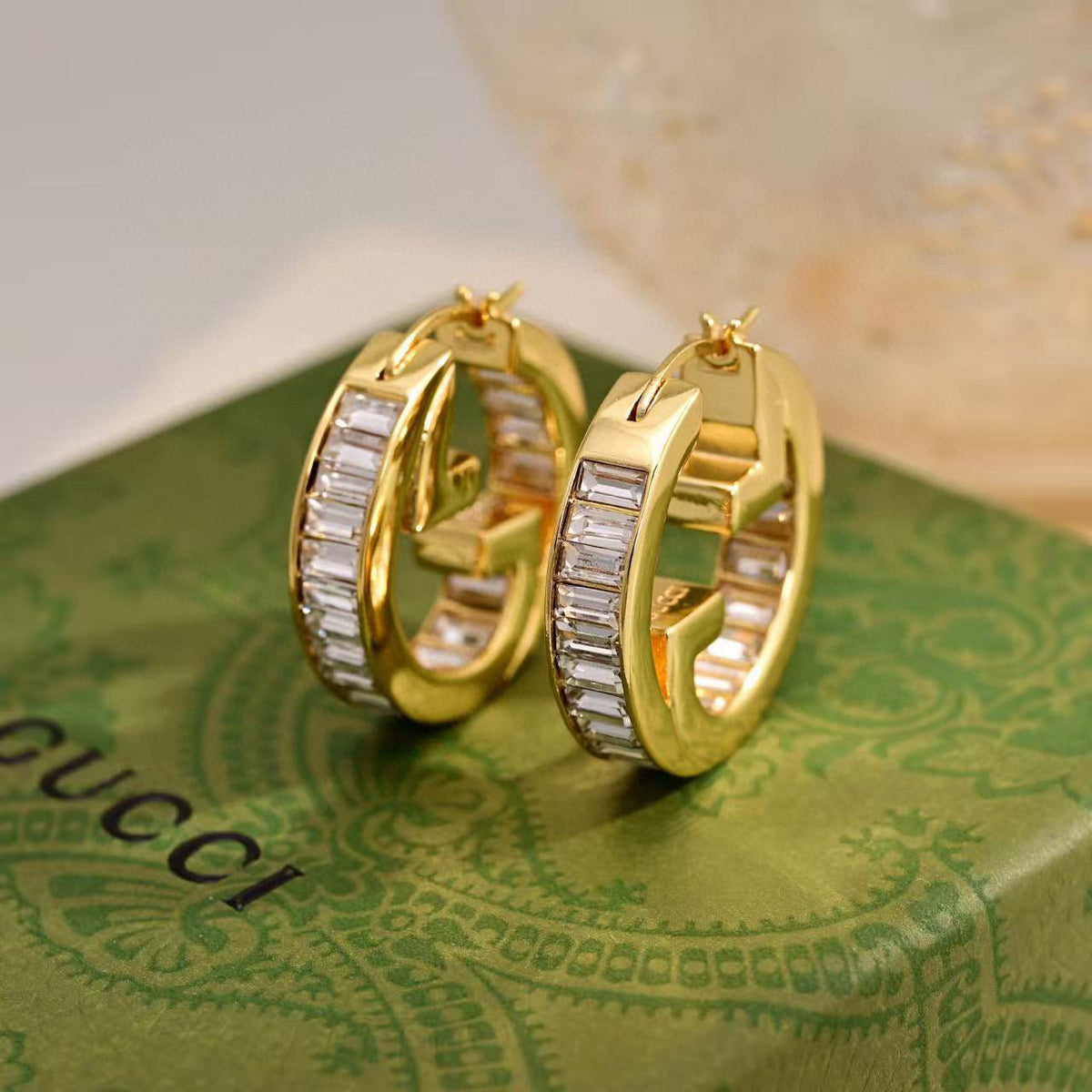 Martin Graham stud earrings in polished metal-tone – styled product view