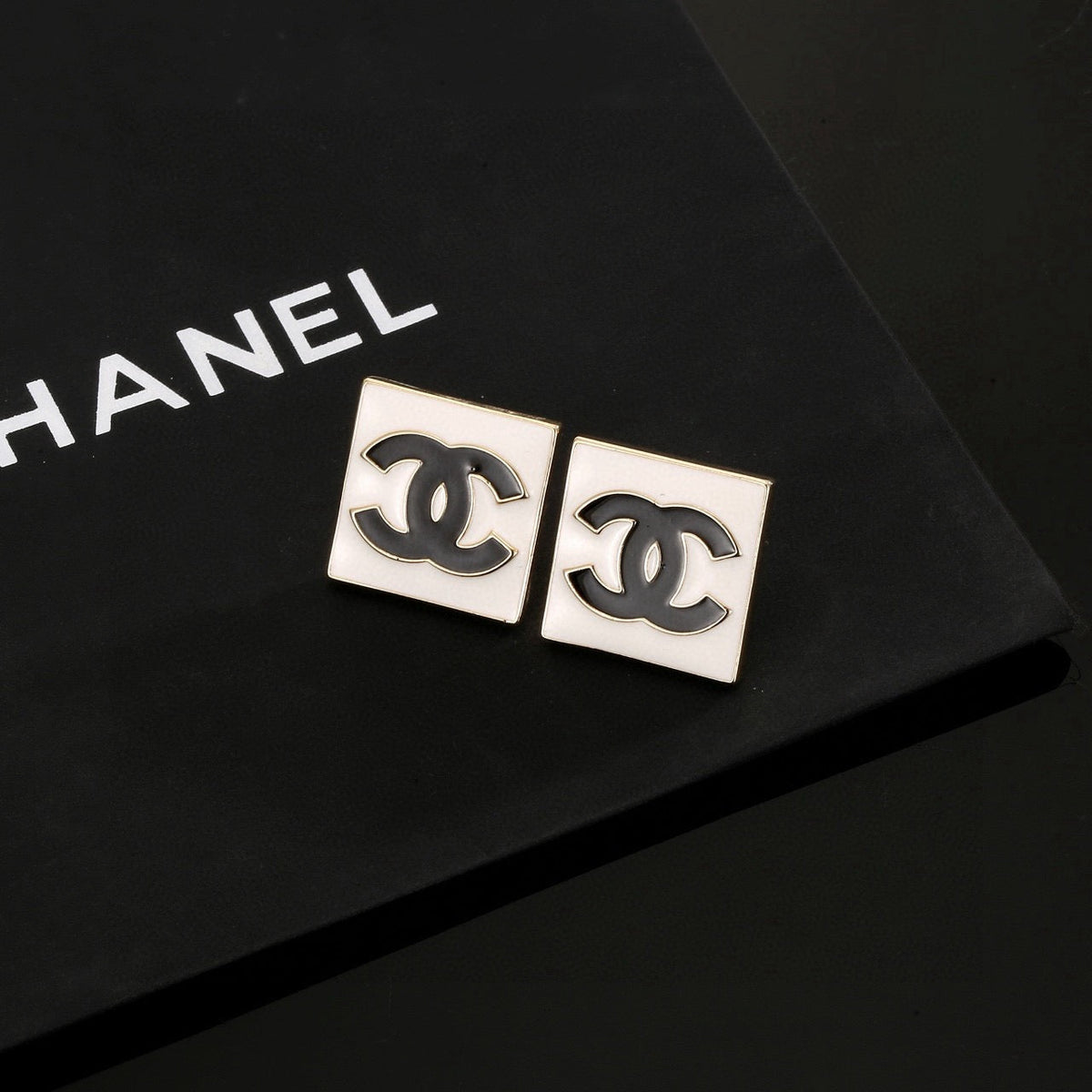 Martin Graham stud earrings in polished metal-tone – close-up detail