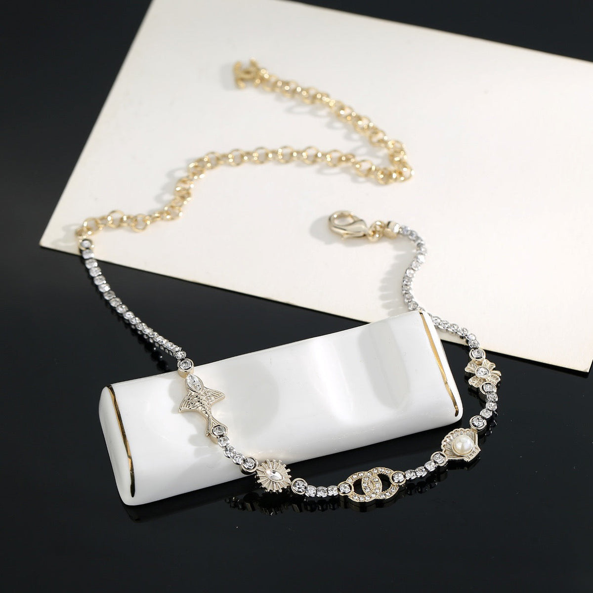 Martin Graham pendant necklace in polished metal-tone – side detail