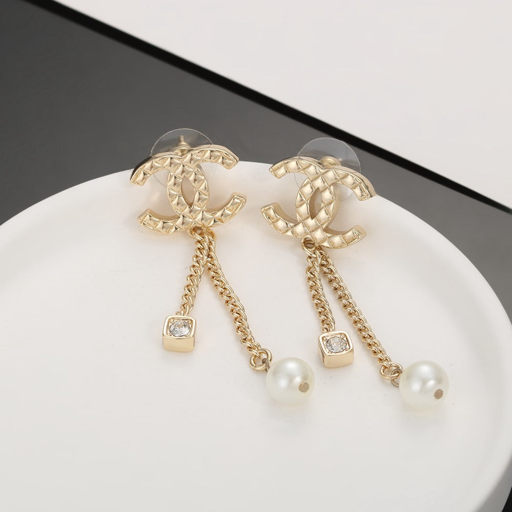 Martin Graham stud earrings in polished metal-tone – close-up detail
