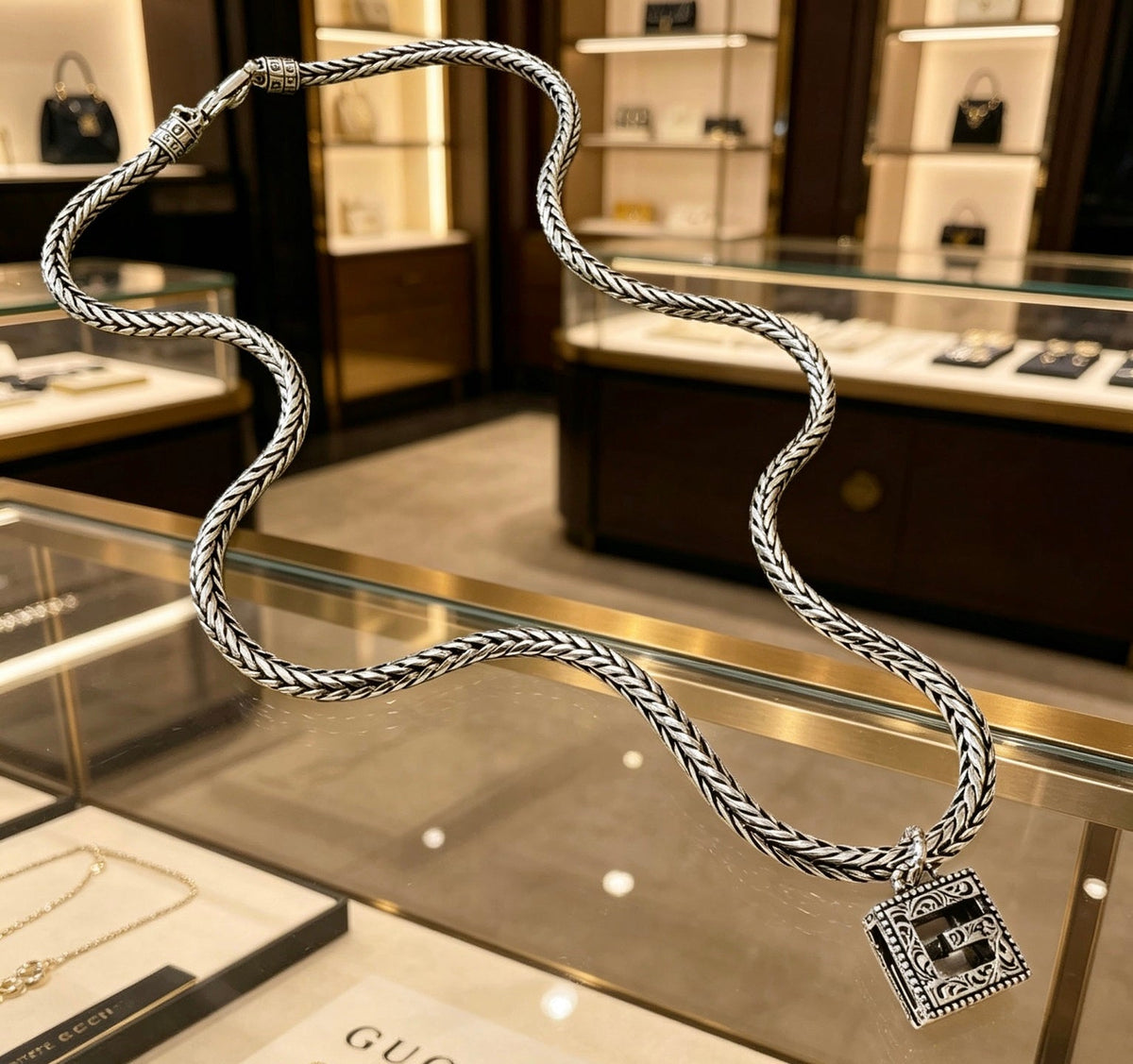 Martin Graham pendant necklace in polished metal-tone – close-up detail