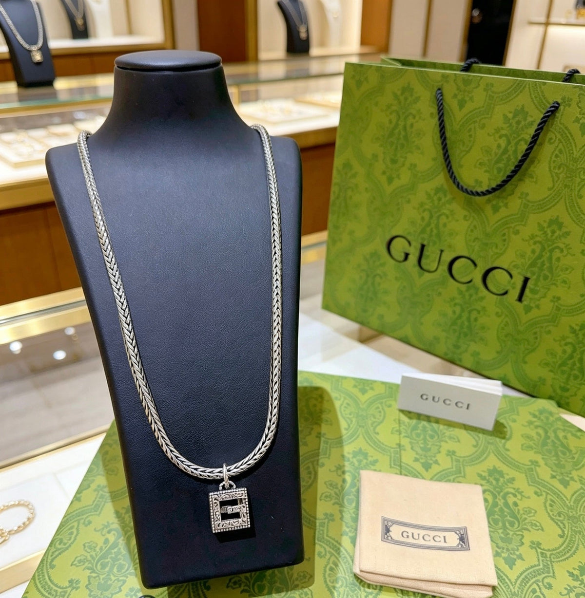 Martin Graham pendant necklace in polished metal-tone – side detail