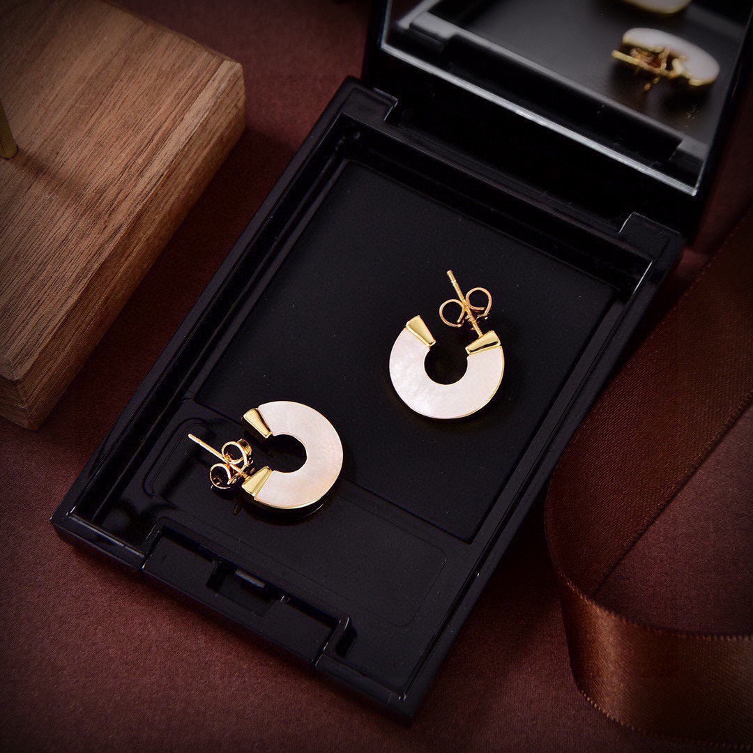 Martin Graham stud earrings in polished metal-tone – close-up detail