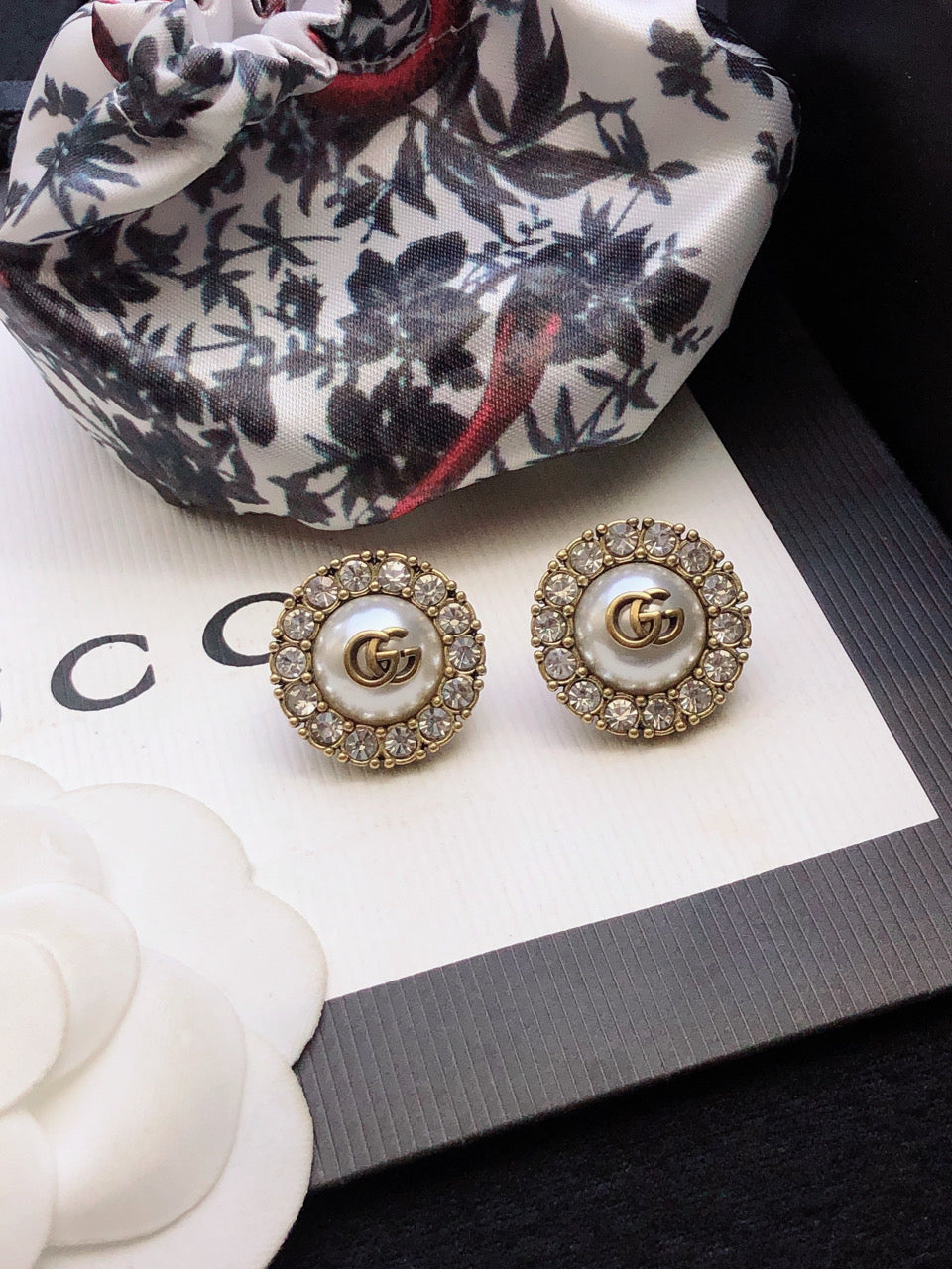 Martin Graham stud earrings in polished metal-tone – close-up detail