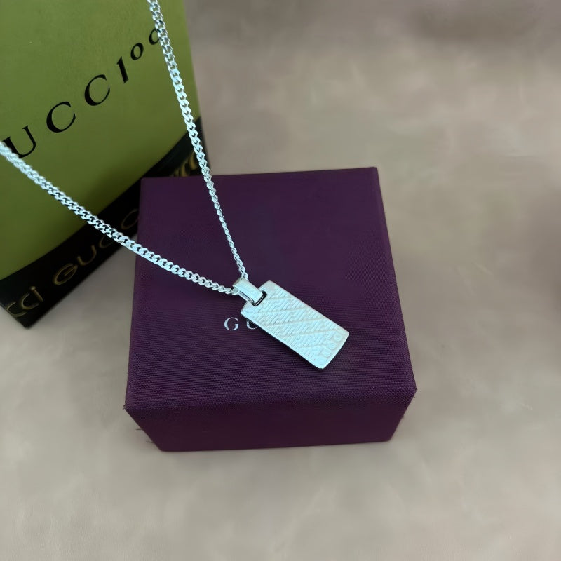 Martin Graham pendant necklace in polished metal-tone – close-up detail